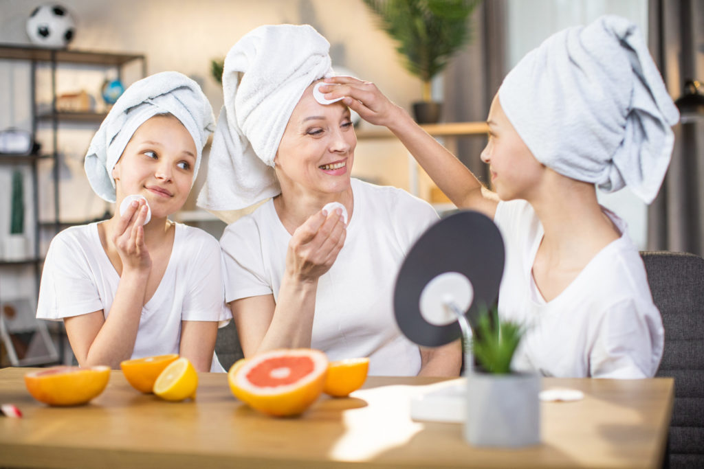 Mother and daughters enjoying beauty routine at home