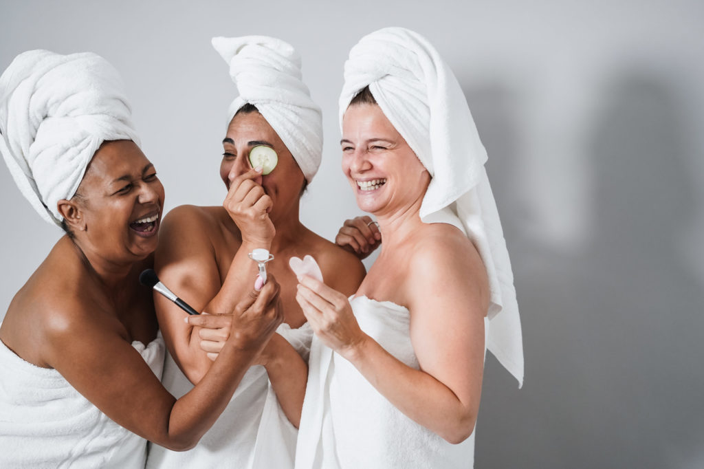 Multigenerational-women-having-fun-using-skin-care-products-Skin-care-therapy