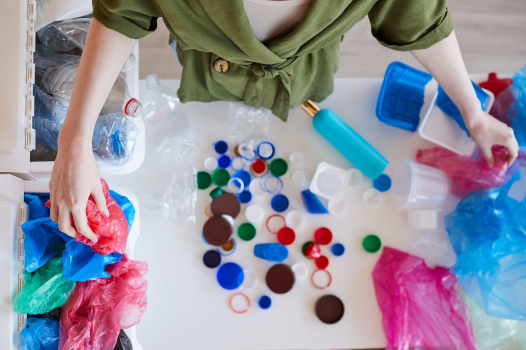 Woman Sorting Plastic at Home Above View